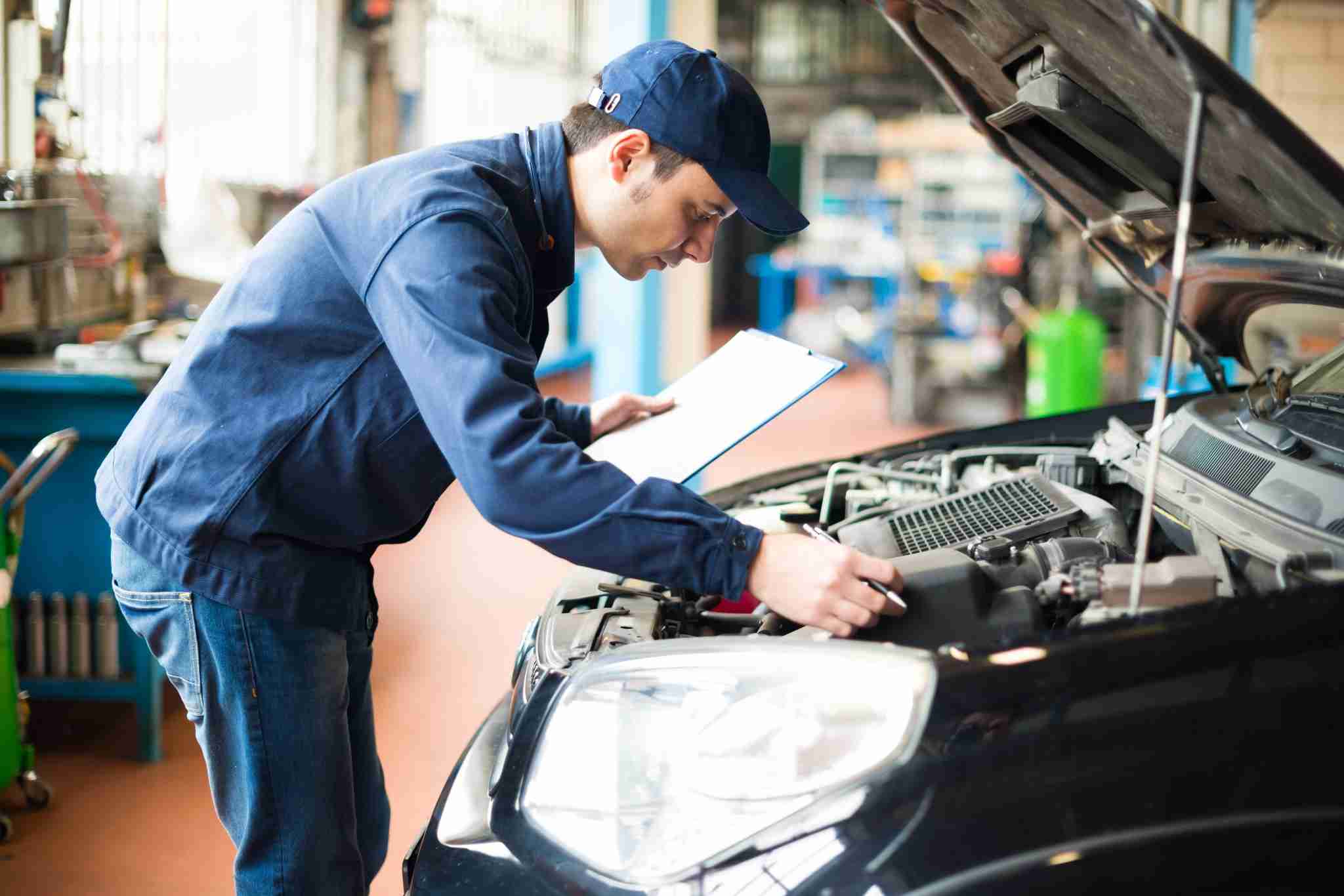 Mechanic checking vehicle