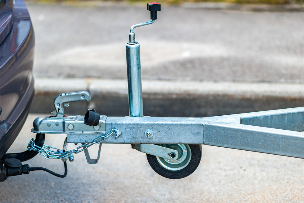 Trailer coupling device for towing a trailer by a passenger car